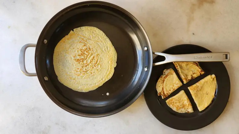 Top view of the pan being used to make crepes.