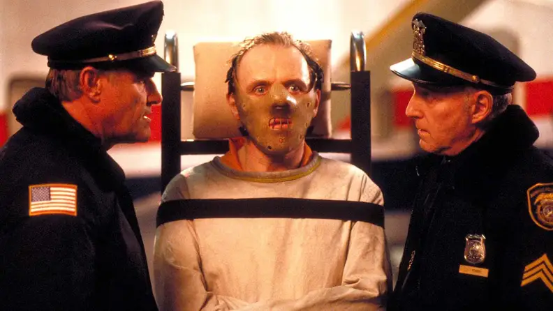 Anthony Hopkins as Hannibal Lecter, surrounded by police officers, in "Silence of the Lambs" (1991), one of the best thrillers streaming now.