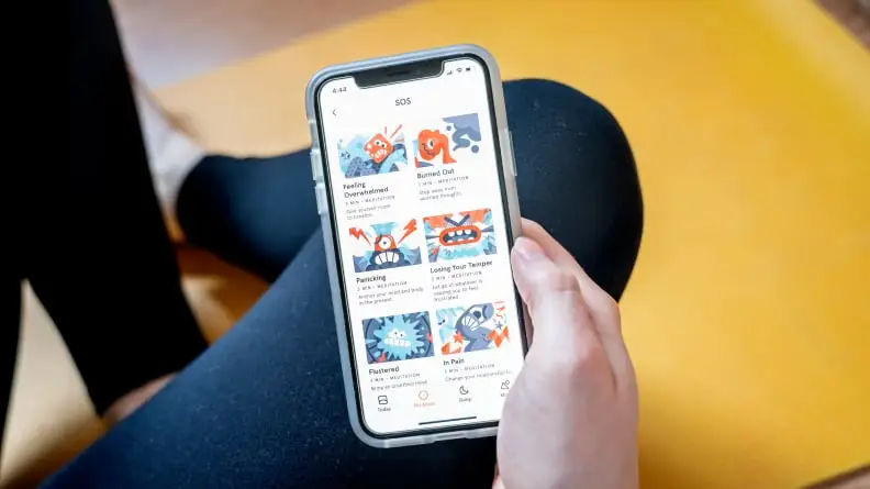 a person holds their phone with the headspace app open