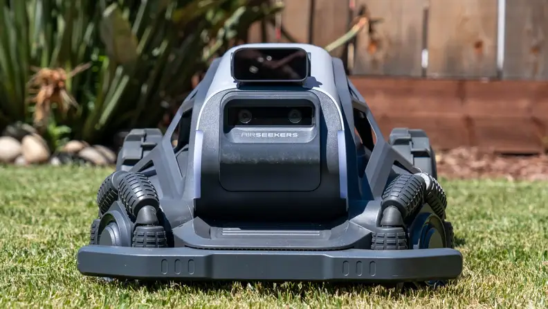 Front view of AirSeekers Tron Robot Lawn Mower sitting on green grass.