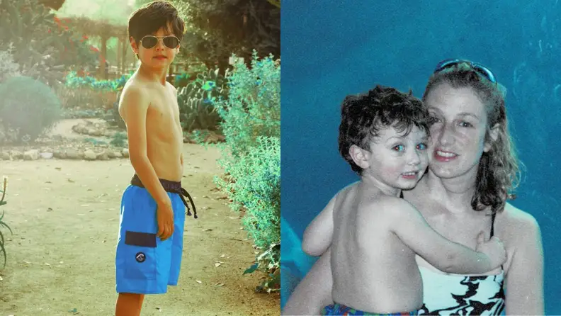 A boy in swim trunks and a mother holding her child
