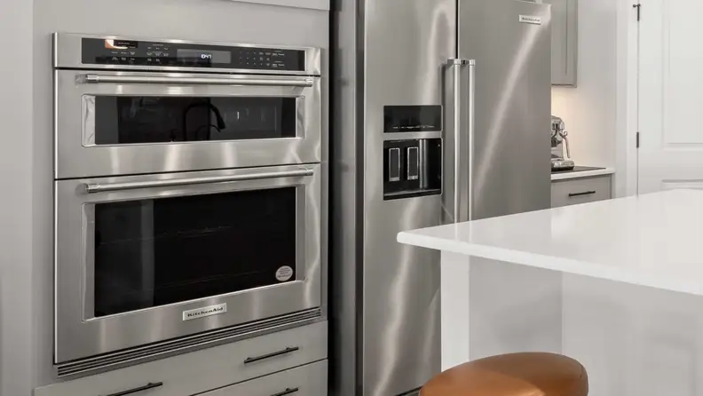 A double oven range with both ovens in use in a kitchen