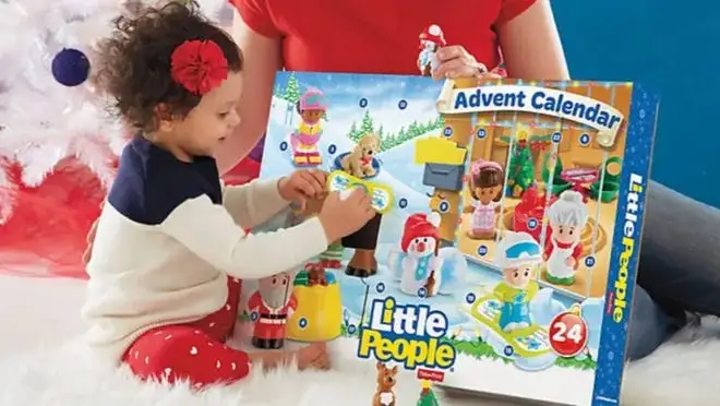 Small child playing with advent calendar.
