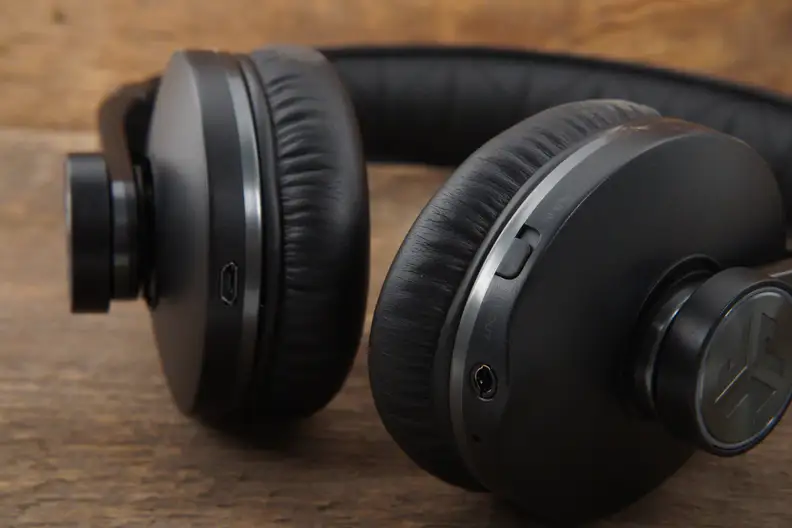 You'll find the charging and audio port on the bottom of the earcups as well as a switch for aux in/out.