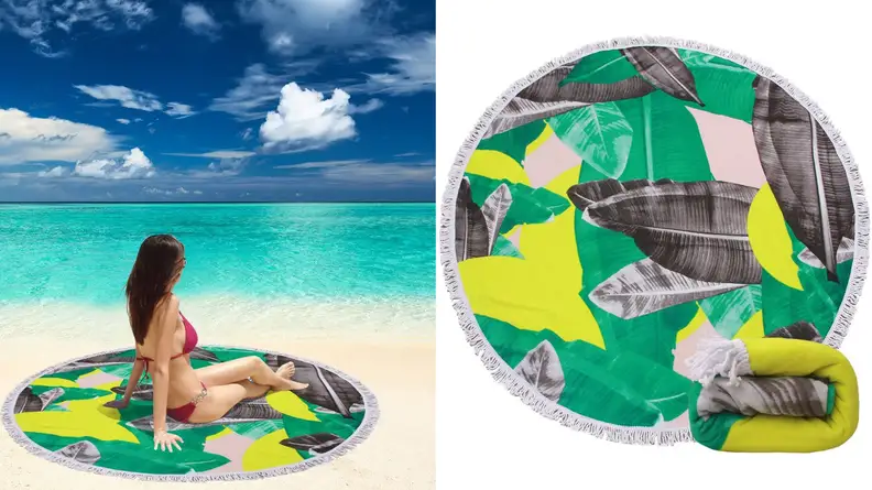 Person on the beach sitting on round towel.