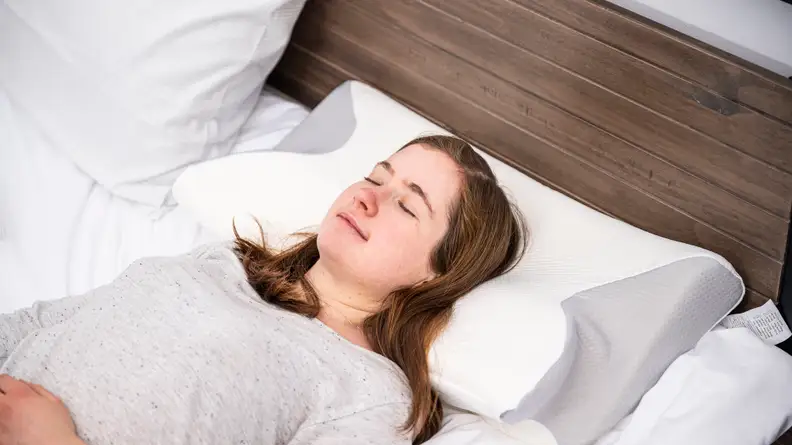 Sara Tabin sleeps on her back on the pillow.