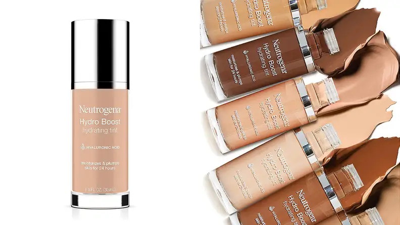 On the left, a light shade of the Neutrogena Hydro Boost Hydrating Tint stands on a white background. On the right, six bottles of the Neutrogena Hydro Boost Hydrating Tint in various shades lay across a white background with the foundation spilling out of them.