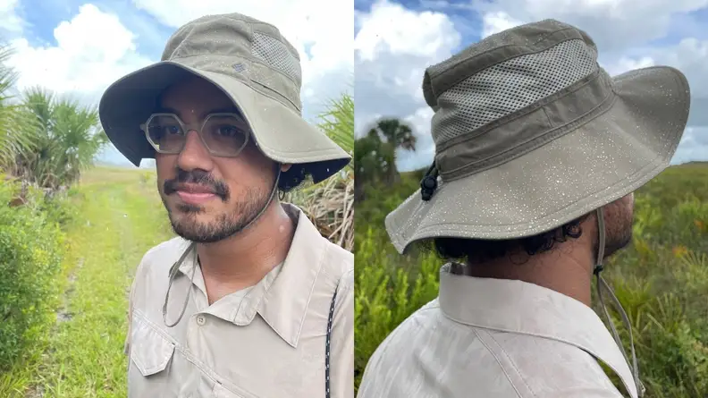 man wearing Columbia booney hat with rain drops on head, back of Columbia booney hat with rain drops