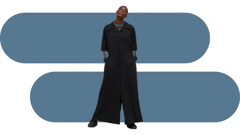 A model wearing an oversized black jumpsuit.