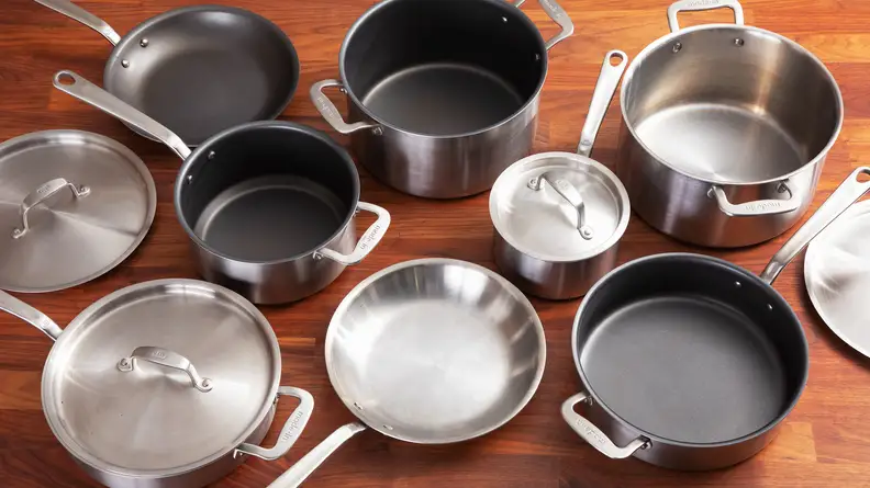 A variety of nonstick and stainless steel cookware, shot from above
