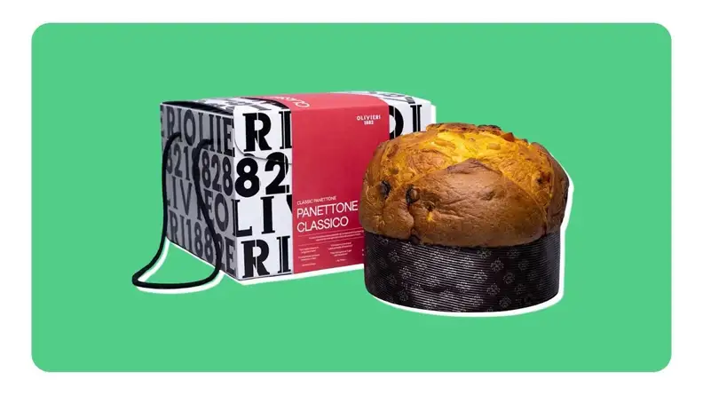 A round loaf of panettone bread from Olivieri 1882 next to a box in front of a green background.