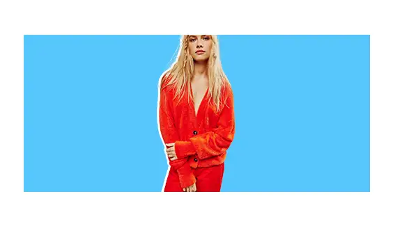 A model wearing a red cardigan.