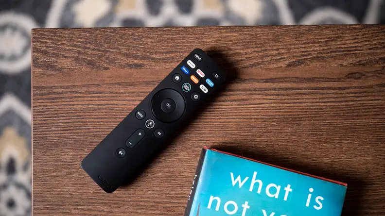 The 2022 Vizio remote control, placed on a coffee table