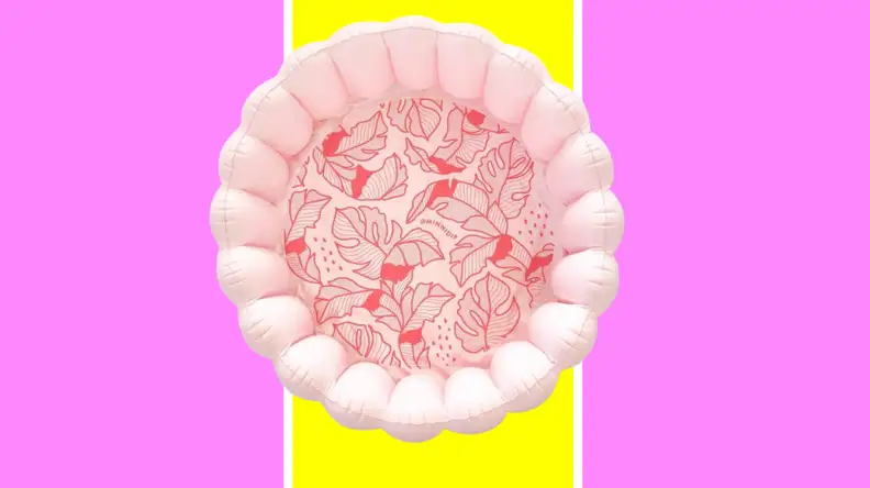 A pink, scalloped pool with red palms