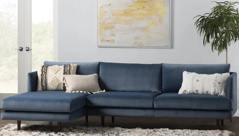 Navy blue couch in a chic living room.