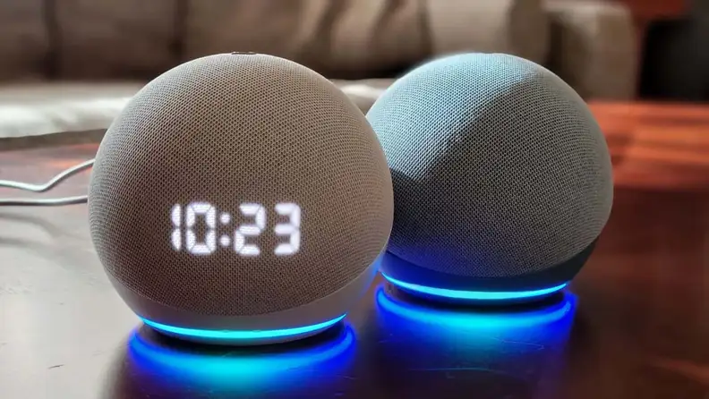 An Amazon Echo Dot tells the time on a nightstand.