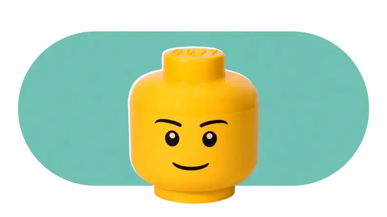A large, yellow, LEGO head that is also a storage bin for LEGOs.
