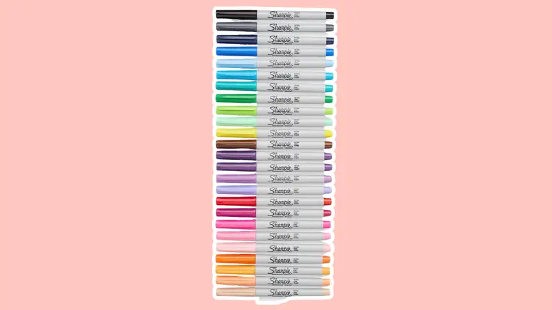 A row of Sharpie pens in different colors on a pink background.