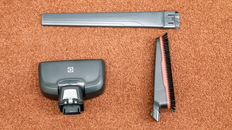 The cleaning attachments for the Electrolux Ergorapido on orange carpet.