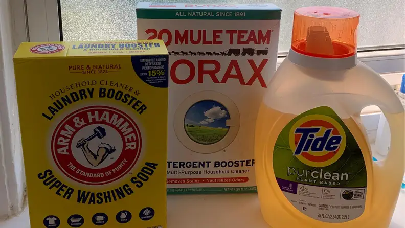 Washing soda, borax, and laundry detergent sitting on a window sill