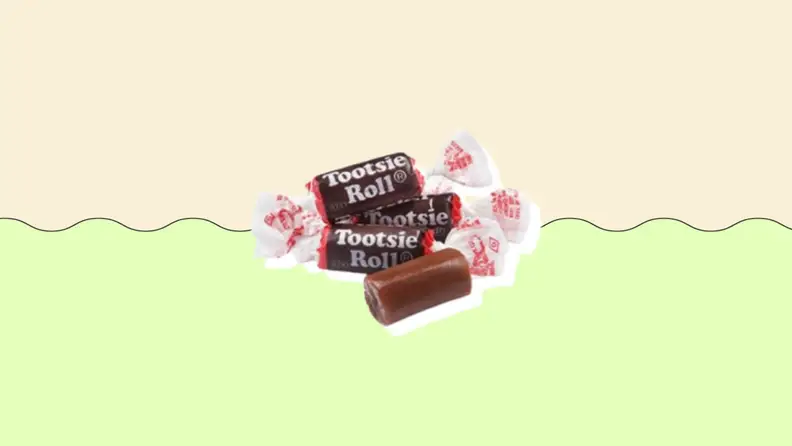 Several Tootsie Rolls on a green and beige background