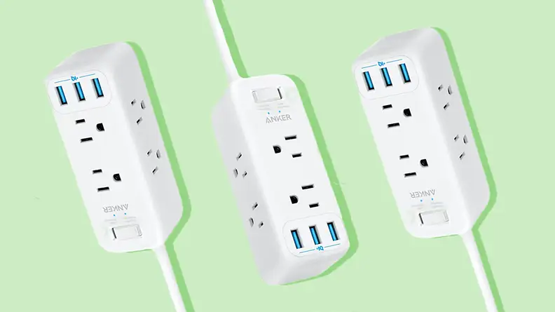 Three white surge protectors against a green background.