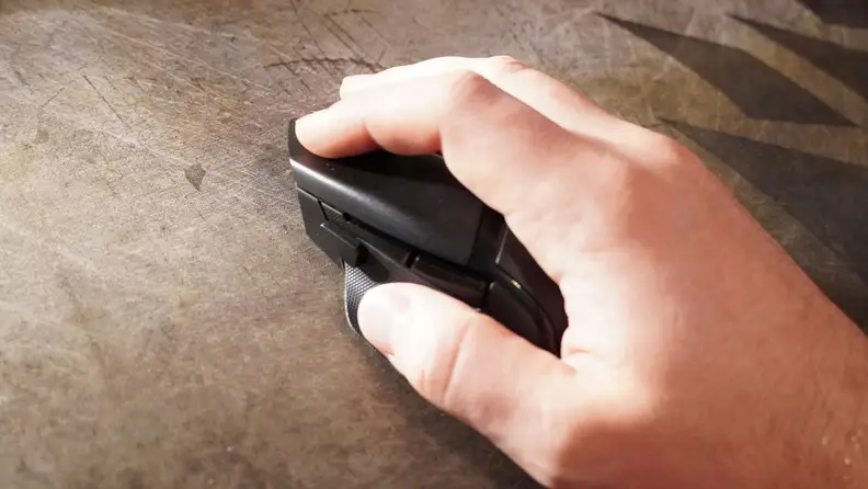 A hand on top of a black gaming mouse