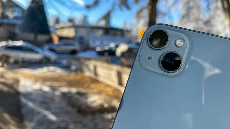 The back of an iPhone that is outside.