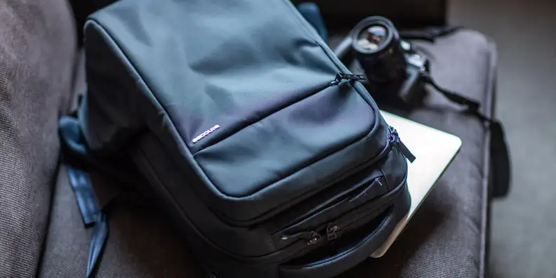 Close up of a black Icon backpack on a sofa.