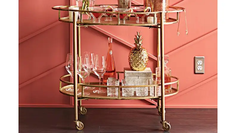A gold Eliza bar cart