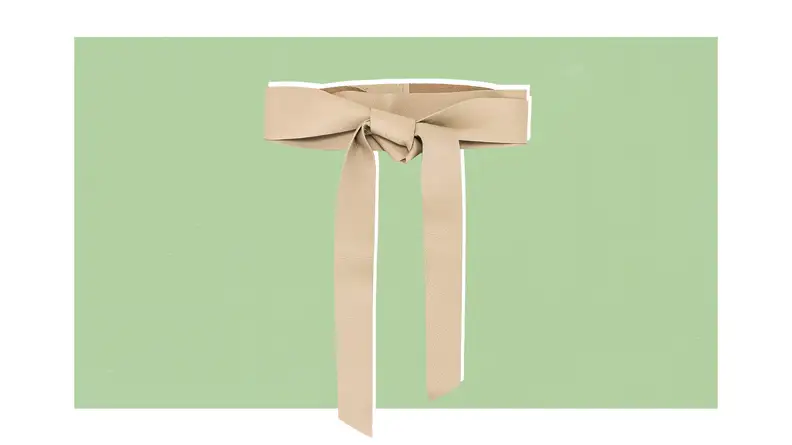 A cream-colored leather wrap belt that is knotted in the front.
