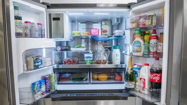 Inside of the Midea MRQ22D7AST French-door refrigerator with food products on shelves.