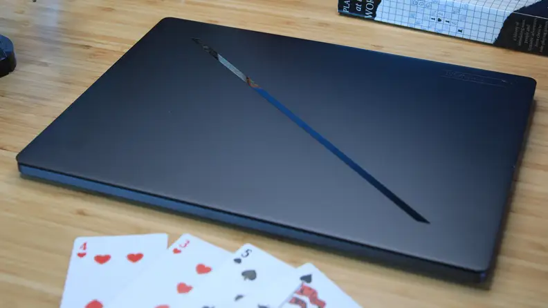 The Asus ROG Zephyrus G16 laptop closed, sitting on a desktop.