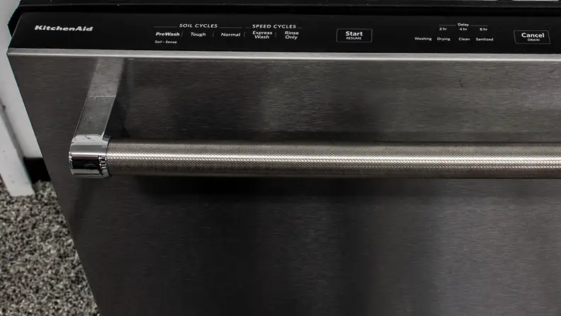 The top-mounted controls of a KitchenAid KDTE234GPS dishwasher.