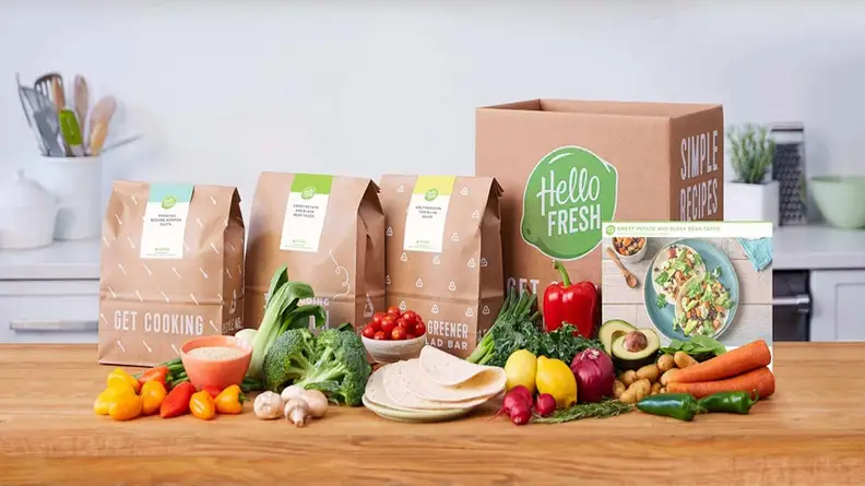 The HelloFresh meal kit contents laid out on a table.