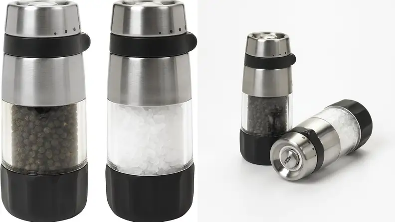 Two manual salt and pepper shakers on a white background
