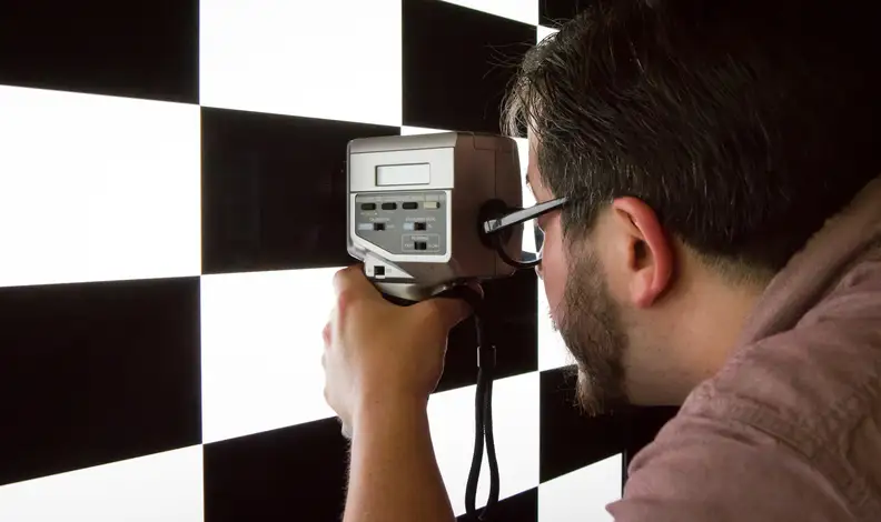 A TV tester measuring a TV's contrast