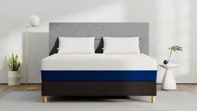 Gray bed frame with white mattress on it.