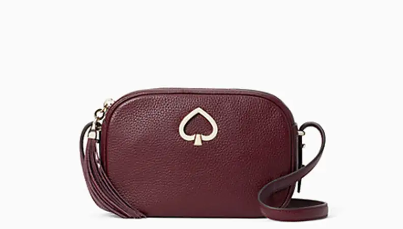 A Kate Spade purse against a white backdrop.