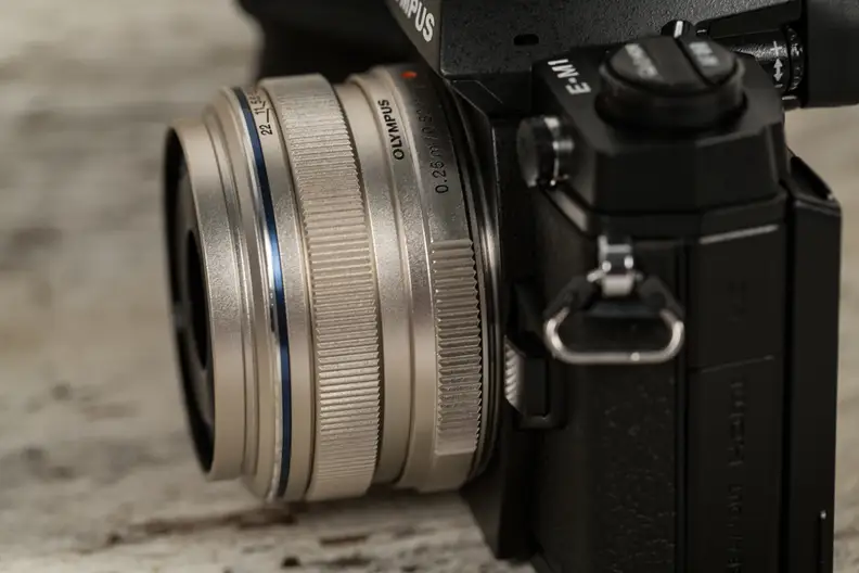 The 17mm f/1.8 is compact enough for travel and sharp enough for most purposes, but it's on the expensive side compared to similar lenses.