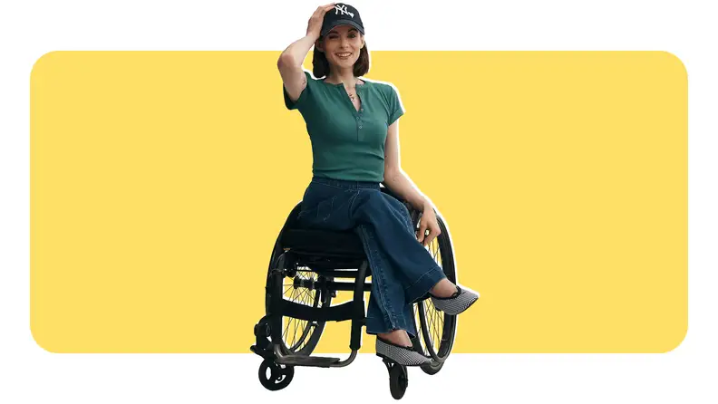 A woman in a wheelchair wearing a green, fashionable top from Anthropologie
