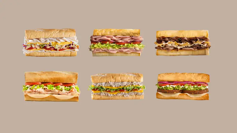 Six sandwich subs on a brown background