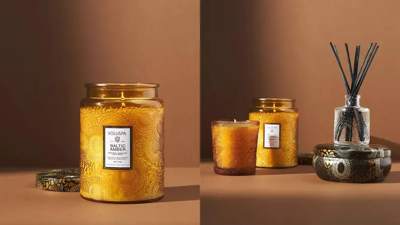 On left, wax candle candle burning in orange, glass jar in front of brown background. On right, several candles and a scent diffuser in front of brown background.