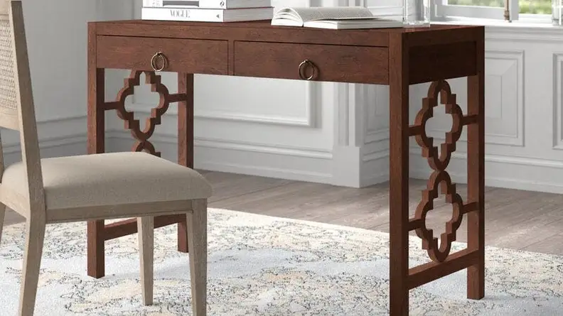 A grey chair and brown home office desk.