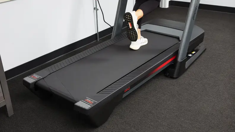 A person's feet walking on the ProForm Pro 2000.