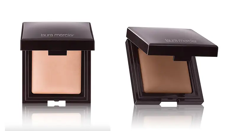 On the left: The Laura Mercier Candleglow Sheer Perfecting Powder compact open to reveal a fair shade. On the right: The compact is open to reveal a dark shade.