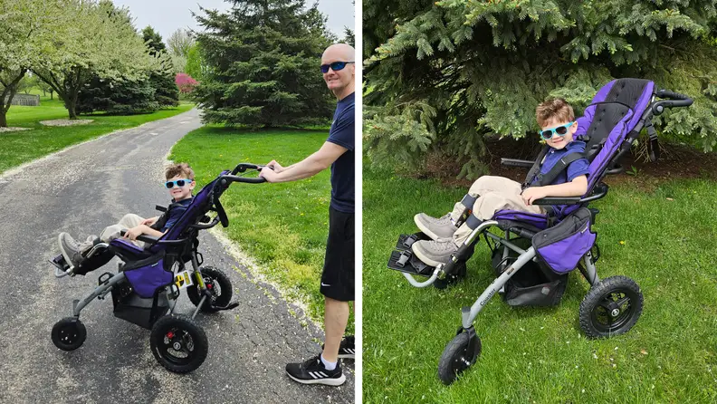 An adult and small child in the Convaid Coaster stroller smile while outdoors together.