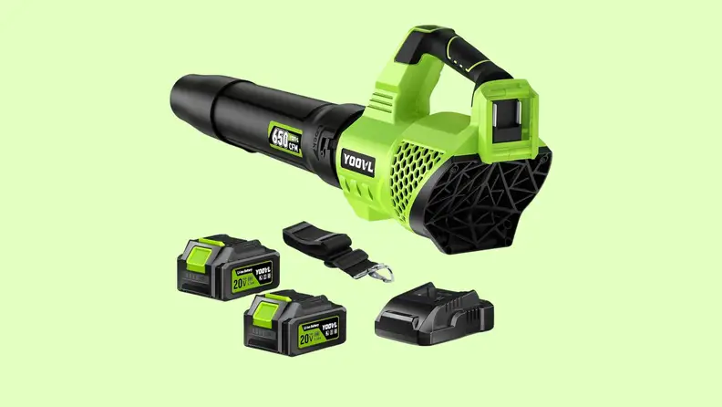 A leaf blower and attachments on a green background