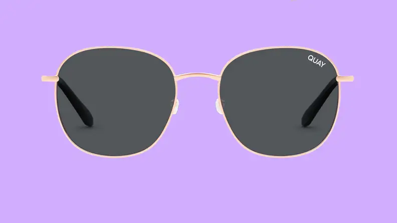 An image of a pair of round, gold-framed sunglasses.