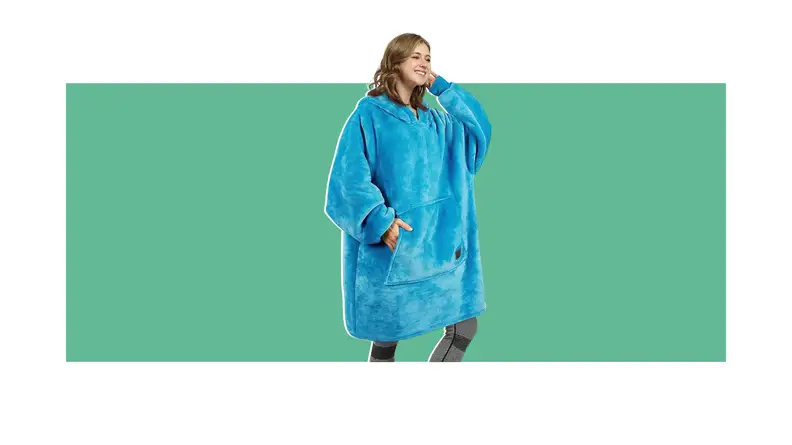 Person posing with arm behind head while wearing blue weighted blanket hoodie.